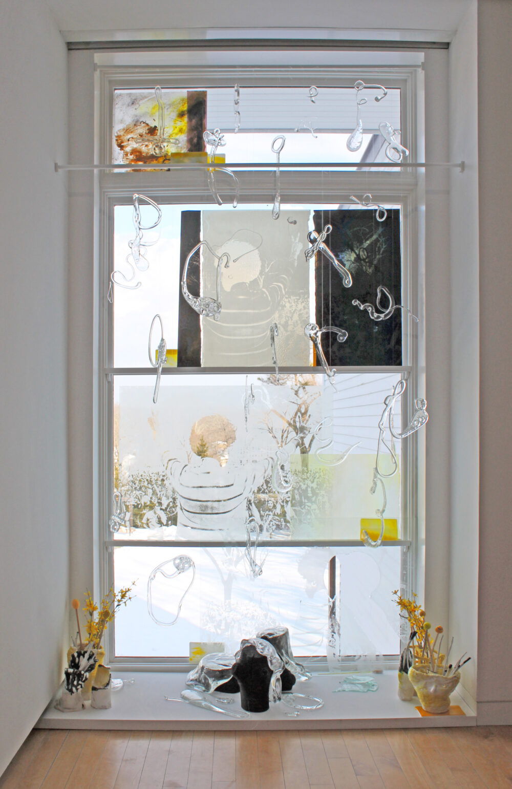 Glass works of art set in a window.