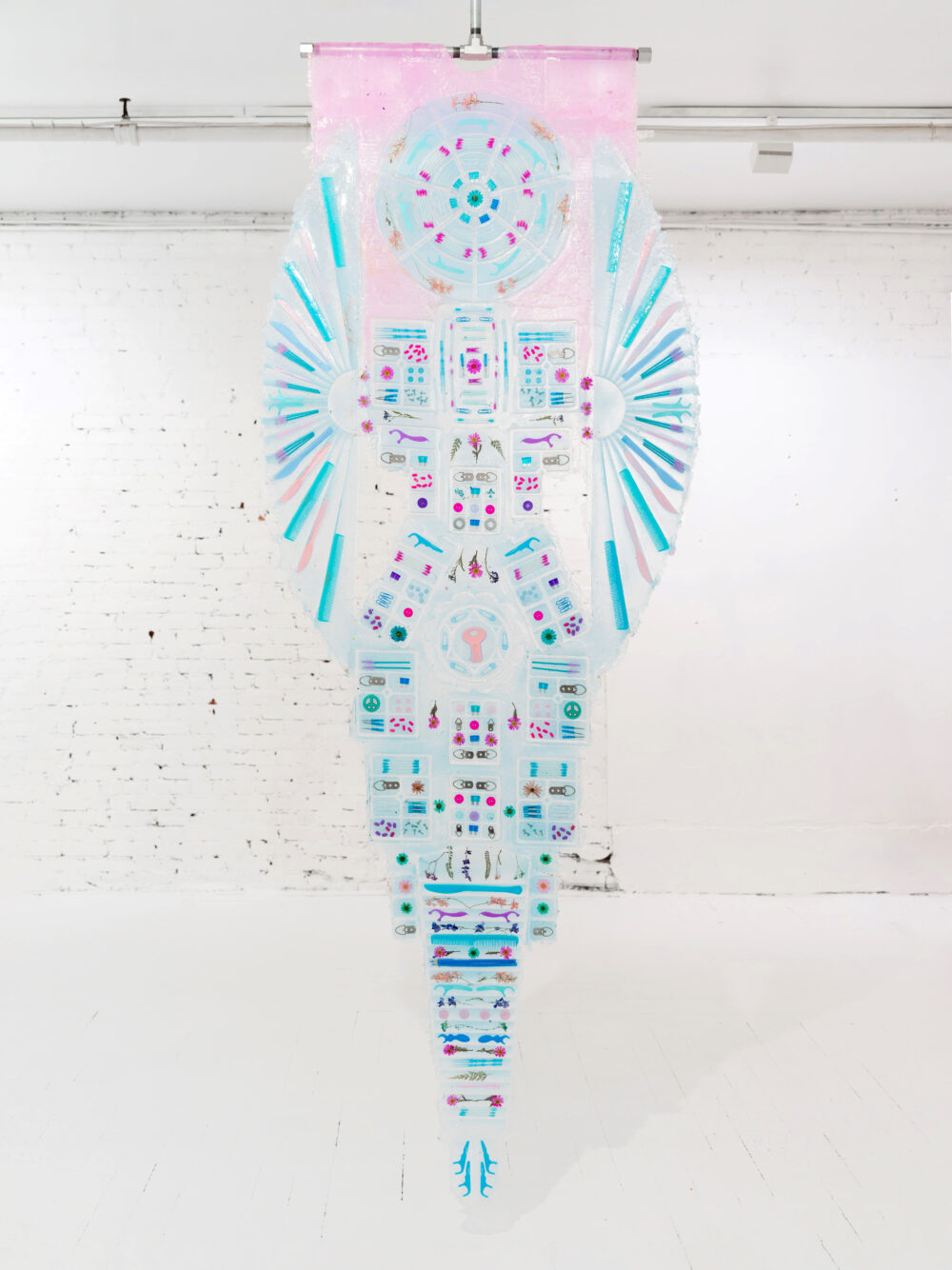 A blue banner made of platinum silicone, pigment, flowers, and miscellaneous objects.