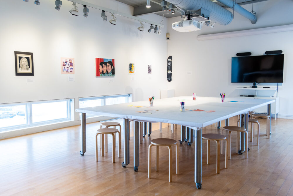 A studio with various portraits on the wall.