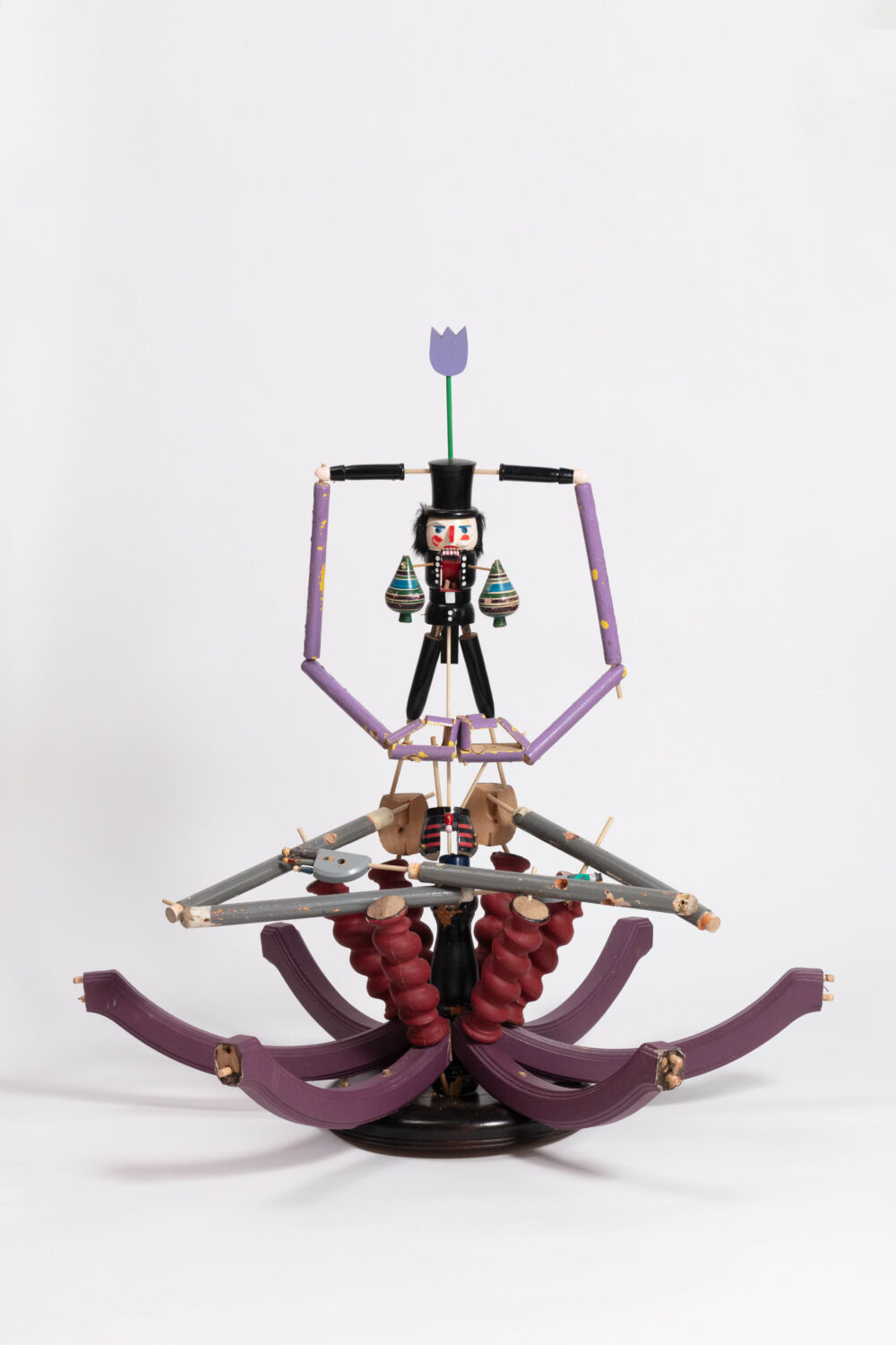 A seated figurative sculpture with a prominent base.