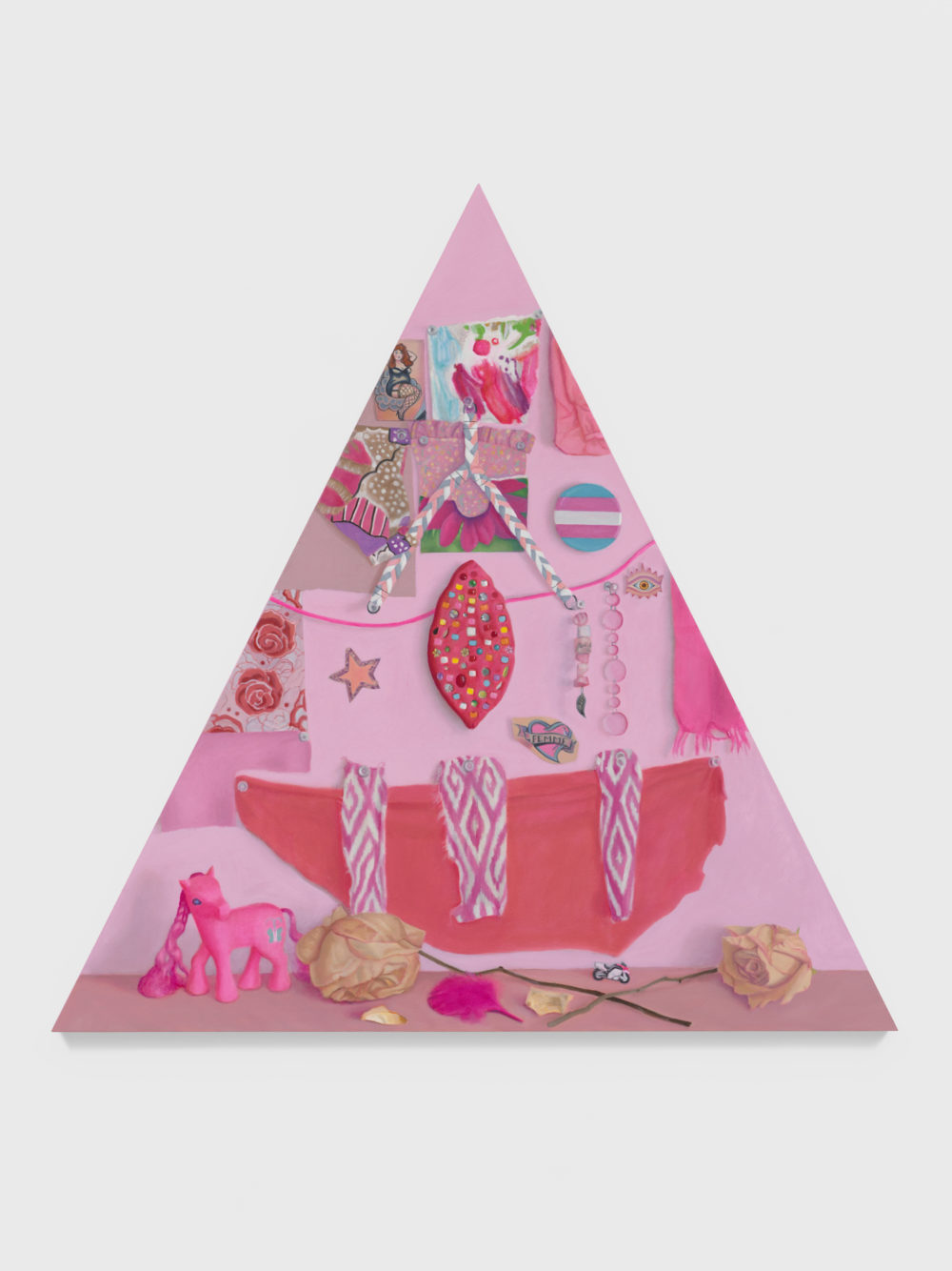 Pink triangle shaped canvas with altar items.