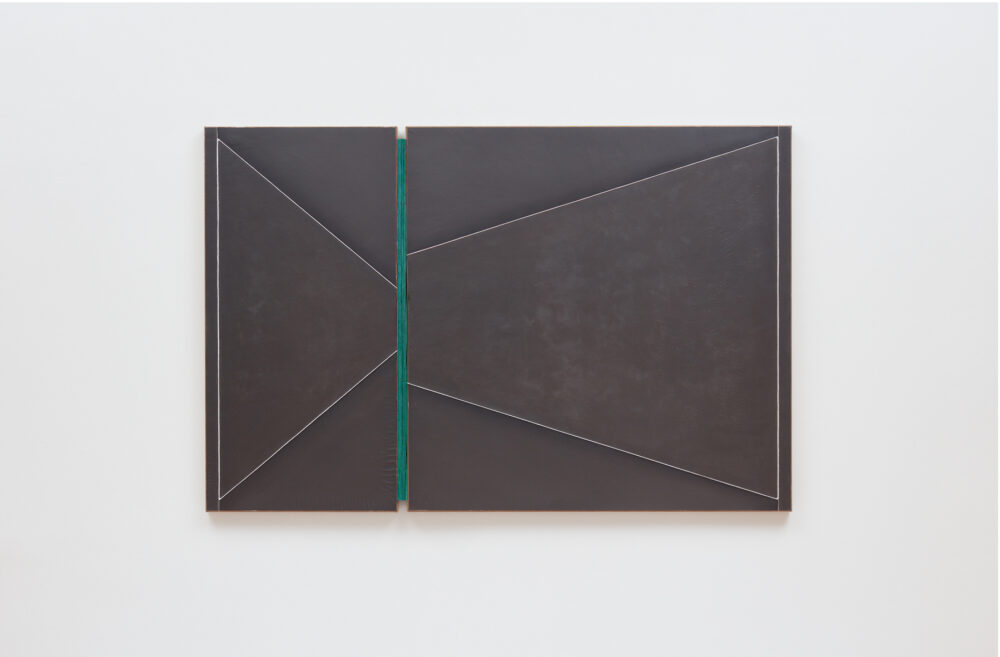 An abstract minimalist dark gray painting on adobe clay with a stripe of green linen