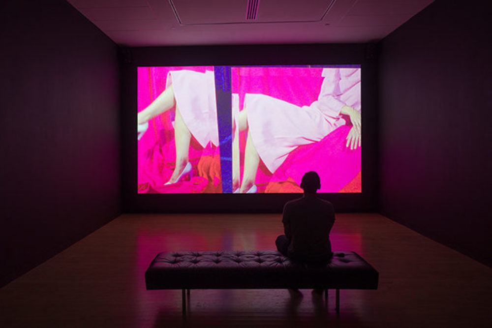 Visitor watches projected video