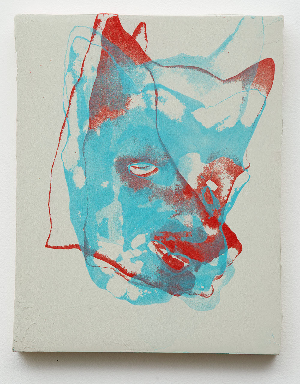 Coyote face in bright teal with red accents.