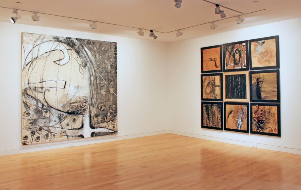 Grid of nine small works on right and a large abstract painting on the left.