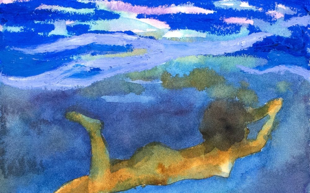 A person who appears to be swimming horizontally through the frame against a blue background.