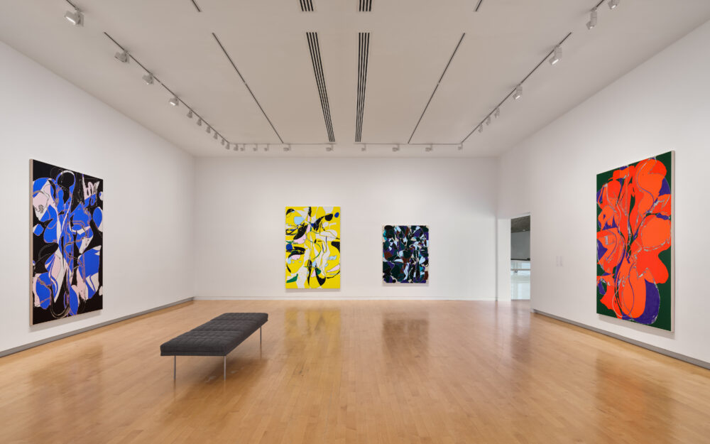 Colorful abstract paintings in a museum gallery.
