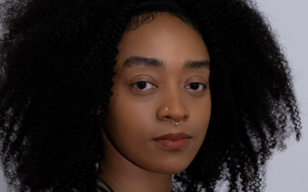 Headshot of a woman starring directly at camera.