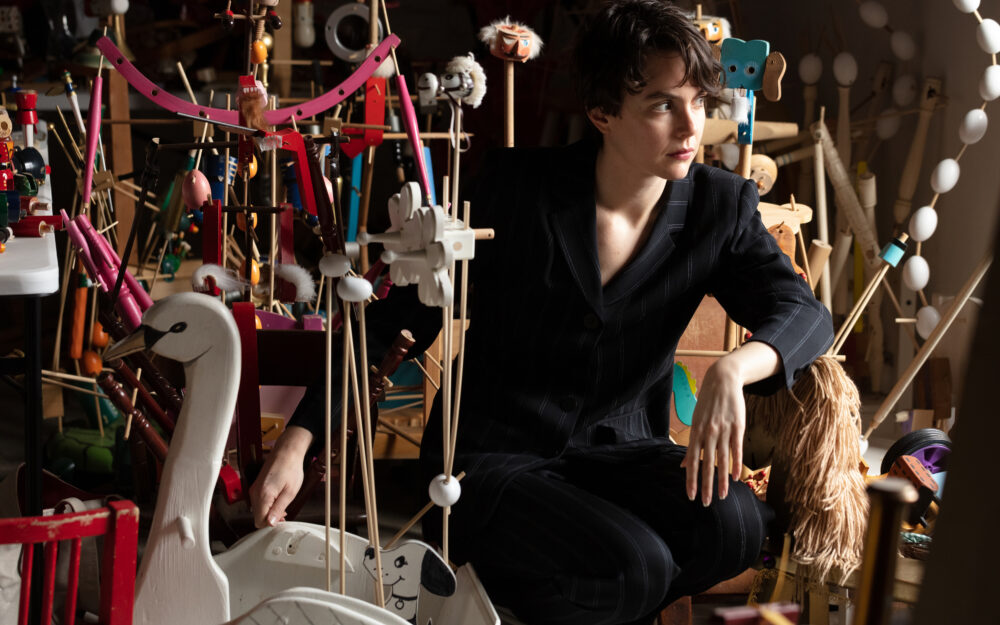 Headshot of Elizabeth Englander amongst her works.