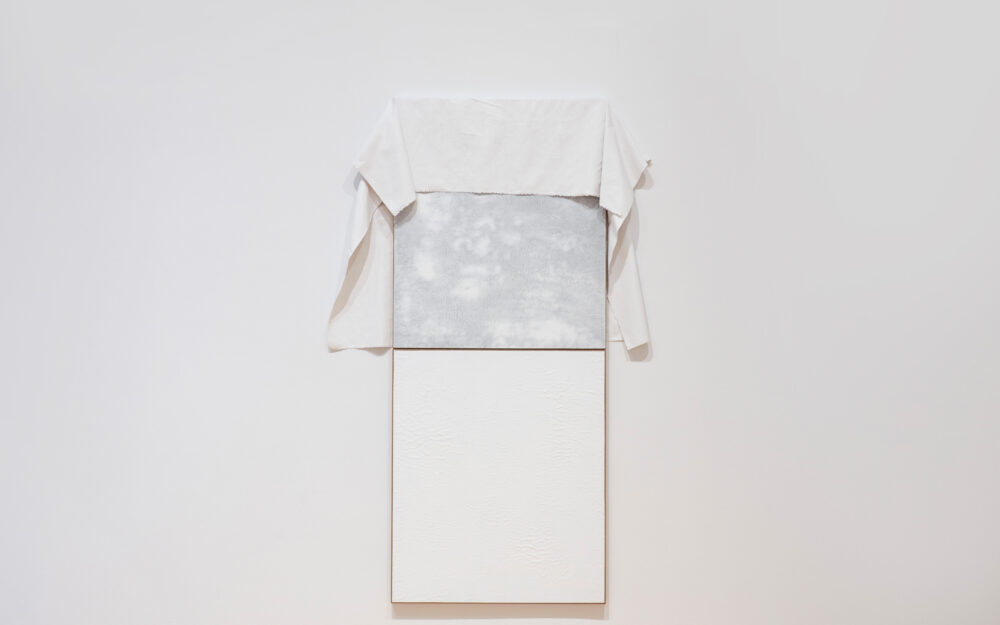 A white artwork in a museum gallery