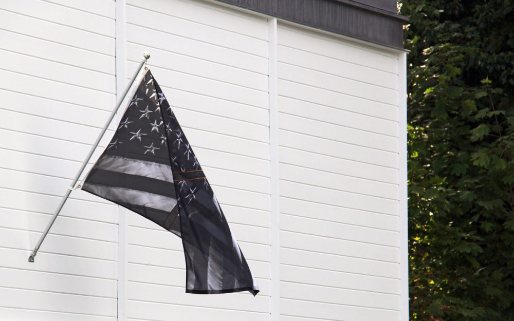 Black American flag hangs on Thee Aldrich's building