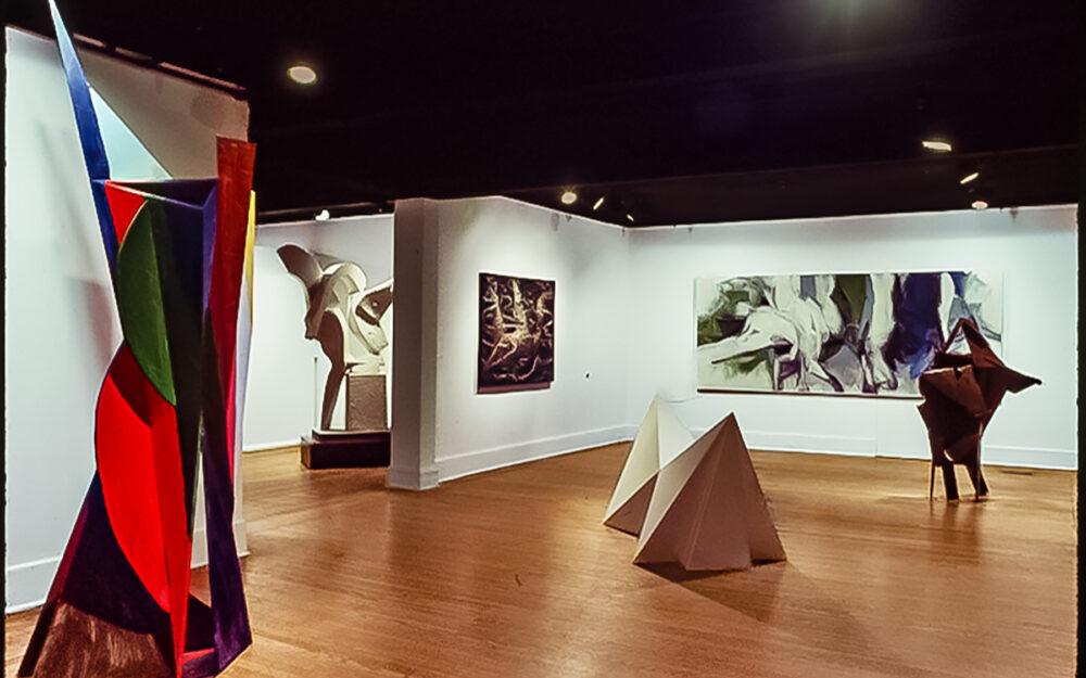 An image of an art gallery with contemporary paintings and sculptures