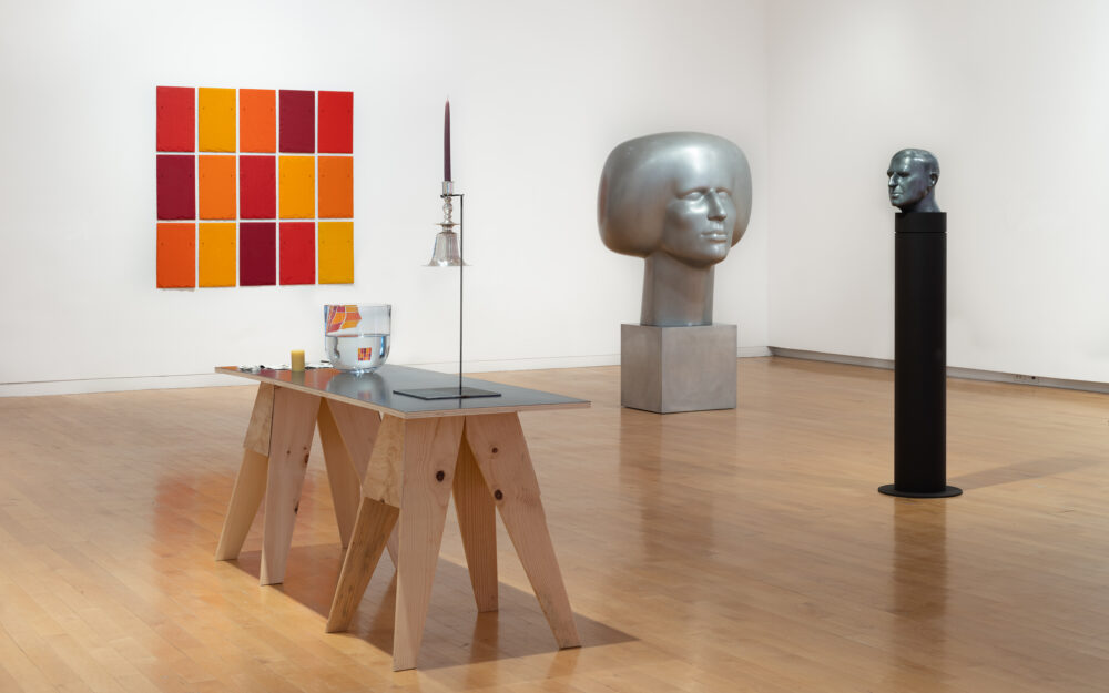 A museum gallery with various artworks relating to the periodic table of elements on display