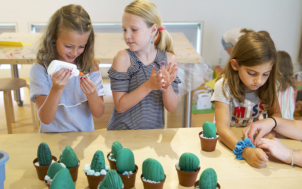 Two young children work on an art project
