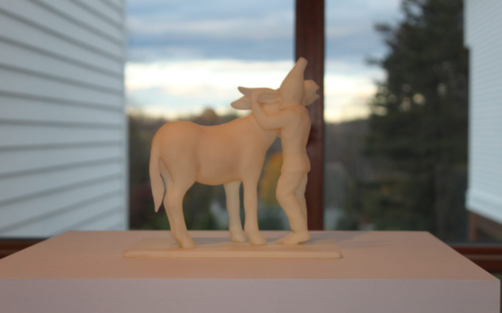 Small figurine of a figure hugging a horse