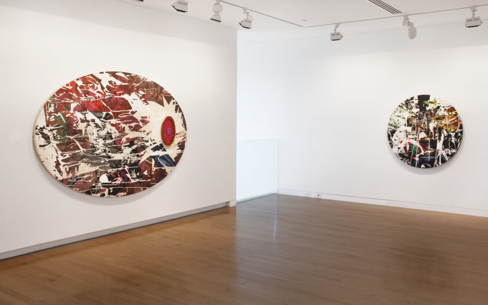 Two oval works on gallery walls