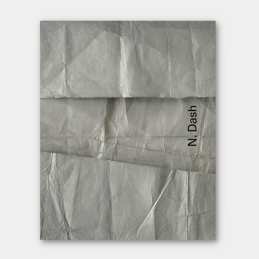 N. Dash Monograph book cover with metal detail pictured.