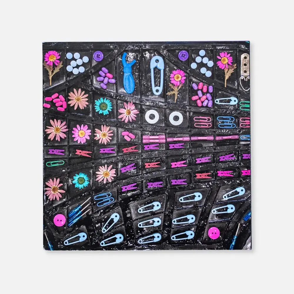 Small colorful objects arranged in swooping rows against a dark background.