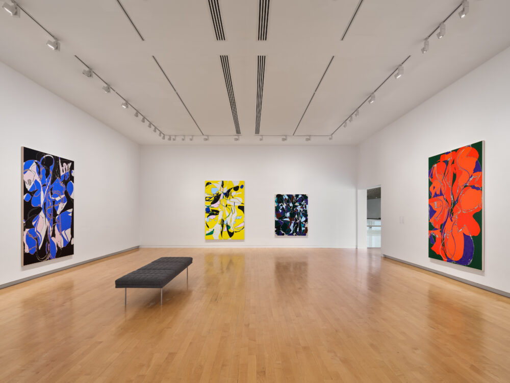 Colorful abstract paintings in a museum gallery.
