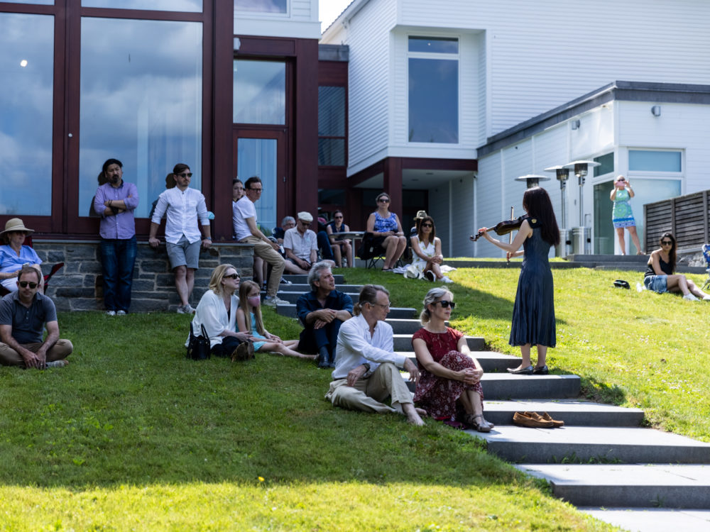 A violinist performs to an audience
