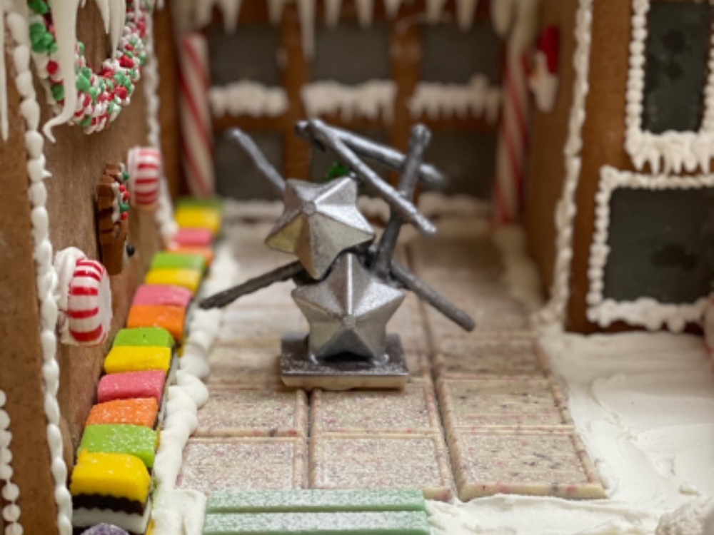 Close up of a chocolate replica of Frank Stella's Stainless split star with truss segments, 2016