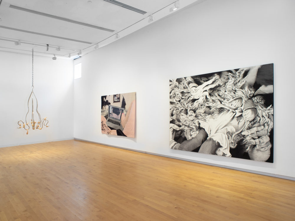Gallery with a suspended sculpture on the far left, a tapestry at center and a large black and white work on paper at the right.