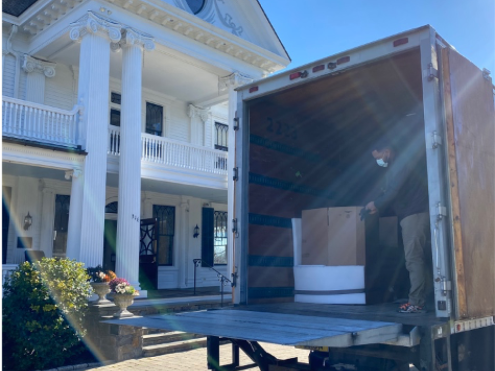 Moving truck with The Lounsbury House in background