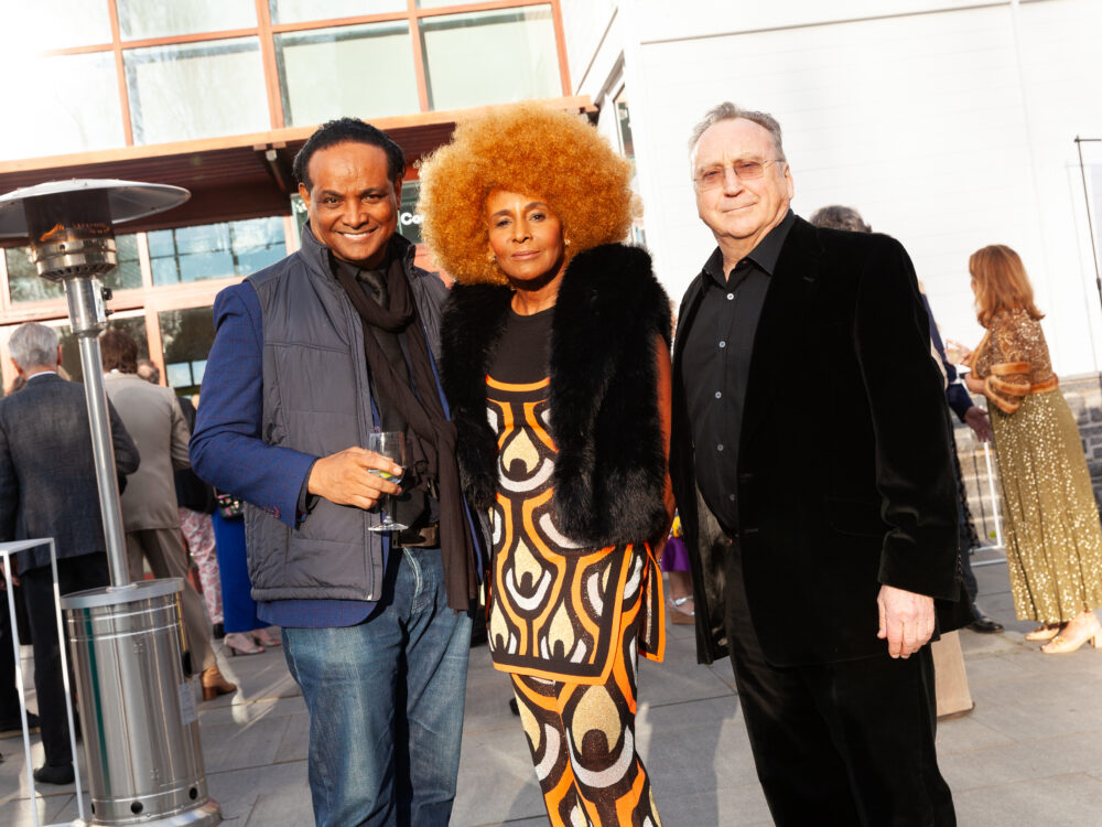 Three guests standing outside the Museum.