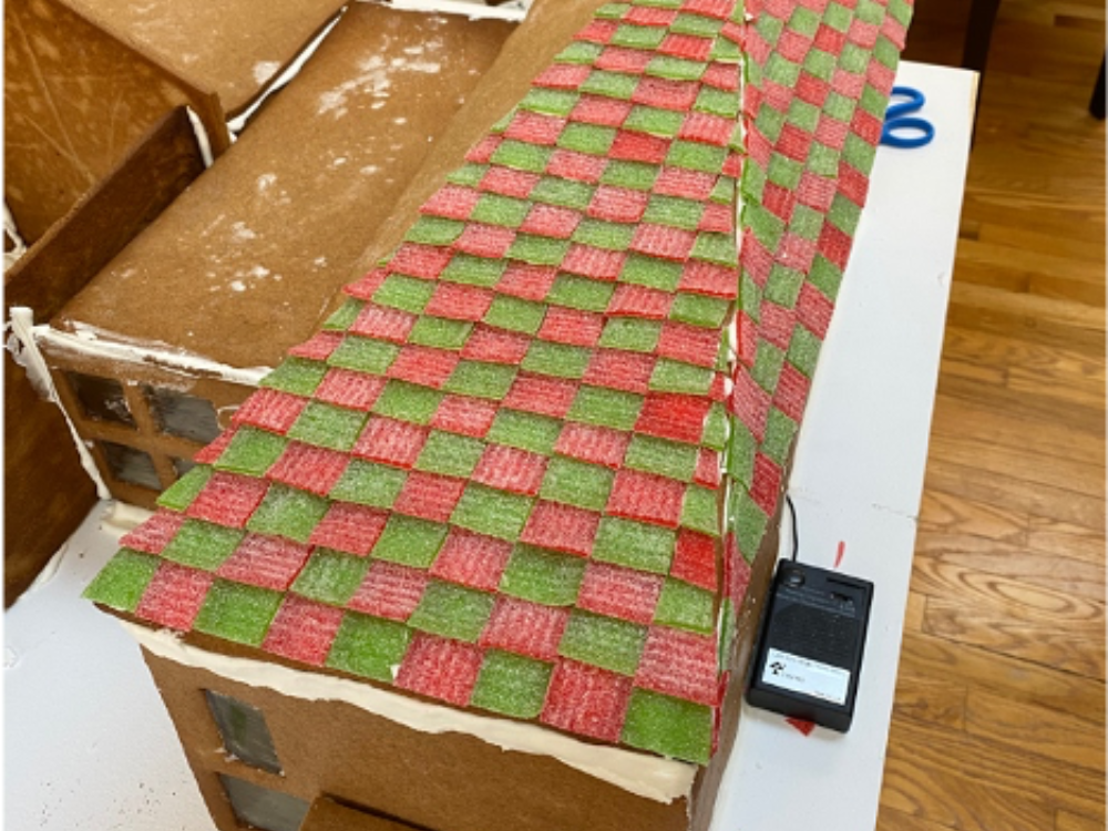 Strips of candy decorating the roof of a gingerbread house