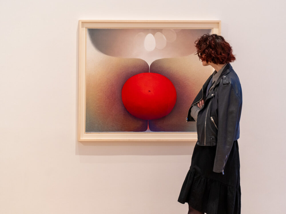 a woman looking at a drawing