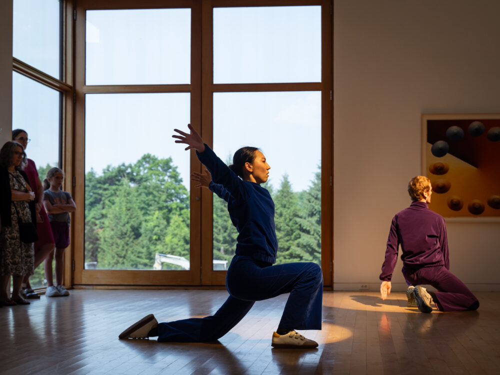 Two dancers lit by spotlights