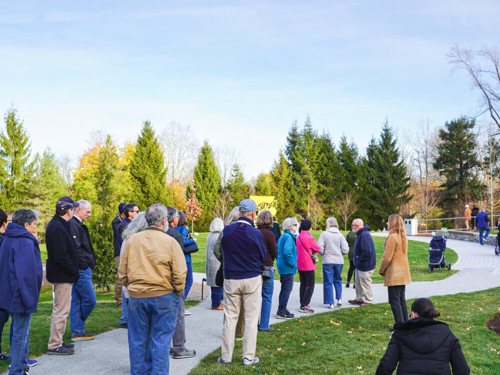 Photo of people viewing artwork in the Sculpture Garden at the All Ages Discovery Tour at The Aldrich.