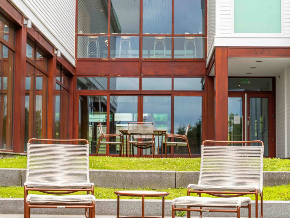 two lounge chairs with a table outside