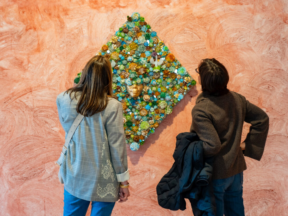 Two people looking at an artwork