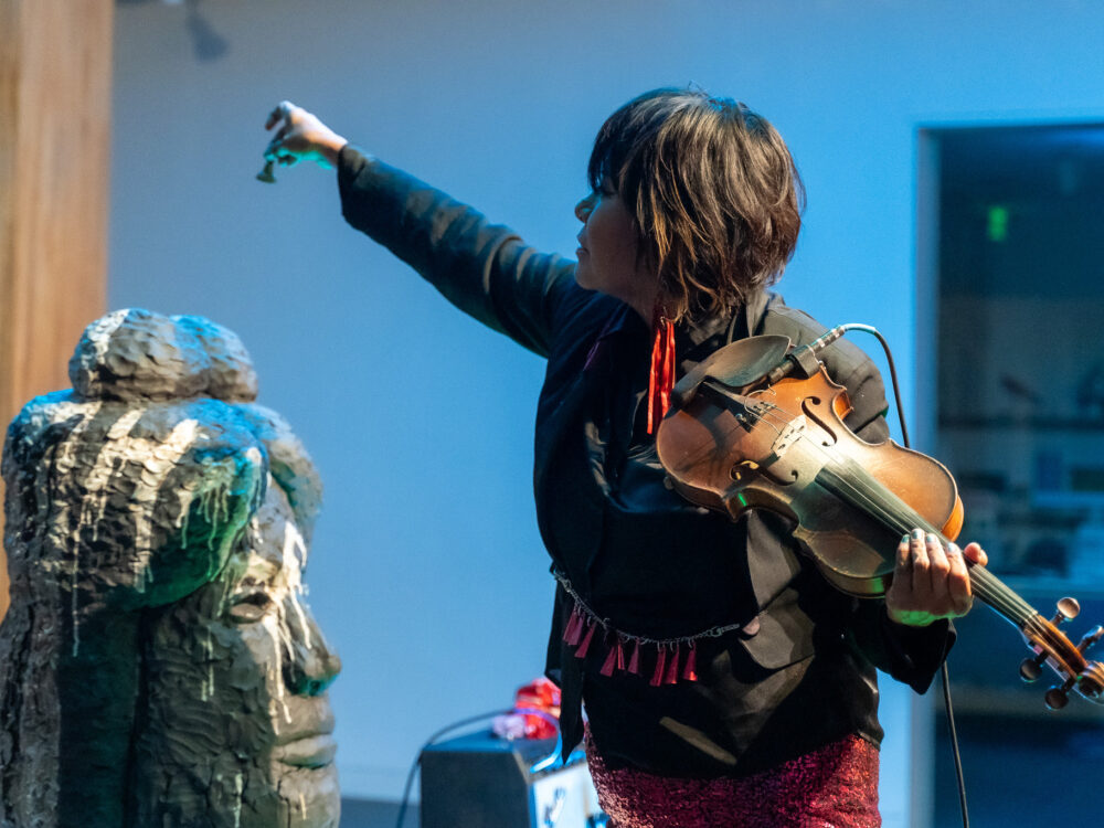 Laura Ortman playing a violin