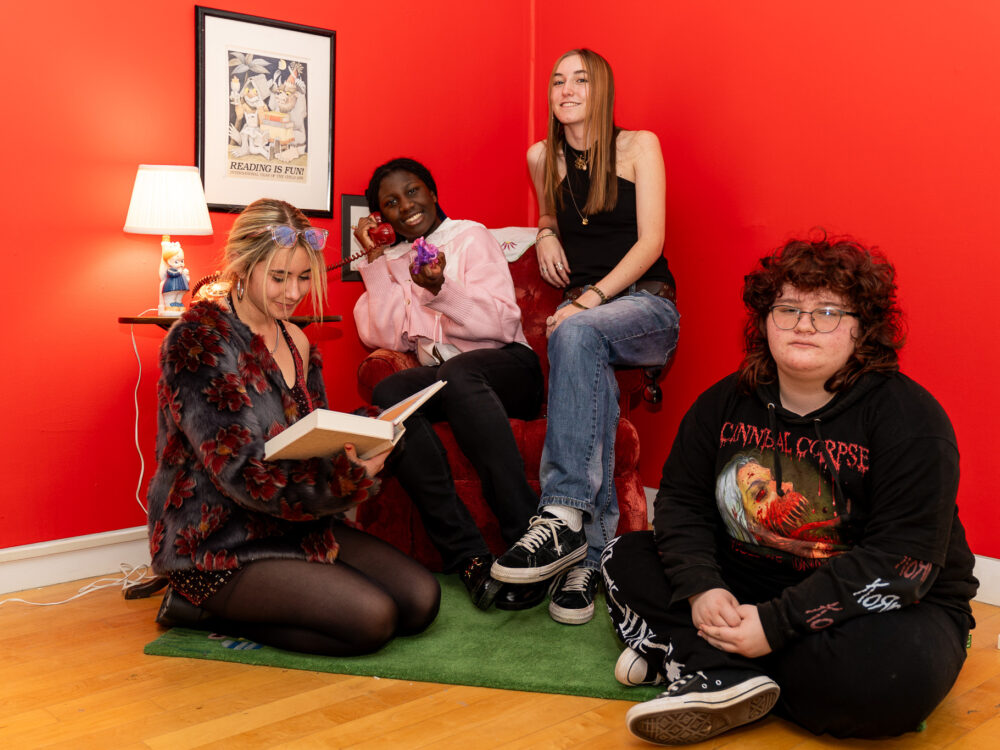 A ground of young people sitting in their art installation