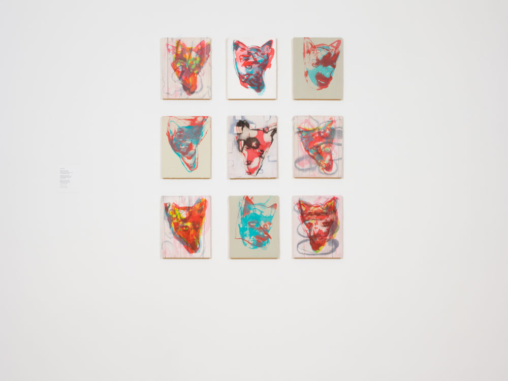 Grid of nine colorful abstract coyote paintings.