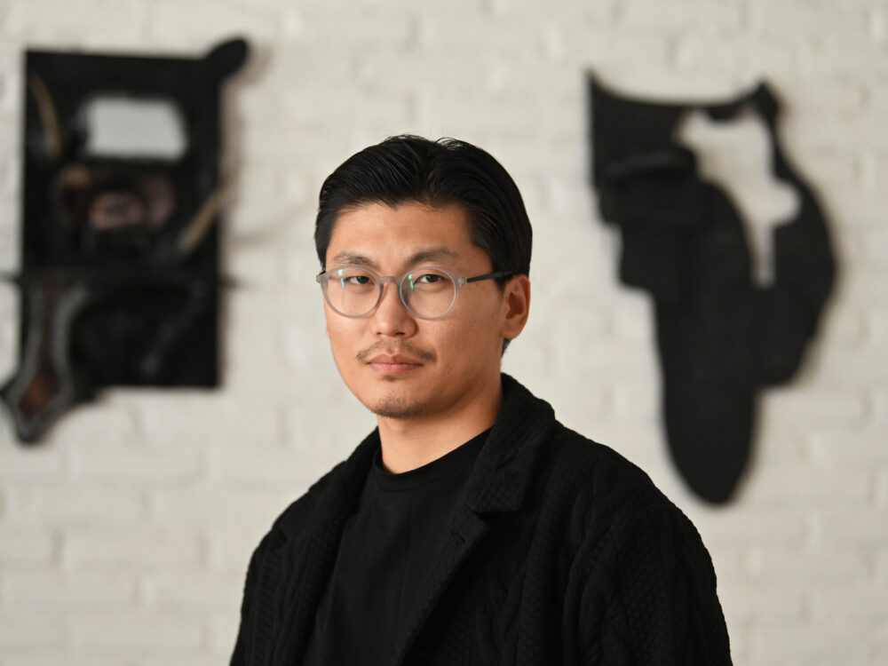 Headshot of a man with short dark hair and glasses.