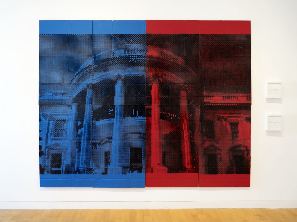 A painting of the White House façade half blue half red with two small framed works to the right.