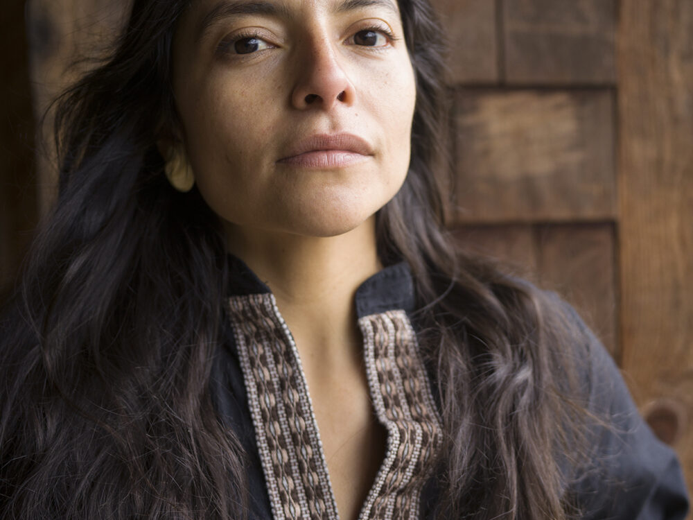 Headshot of a woman with long dark hair.