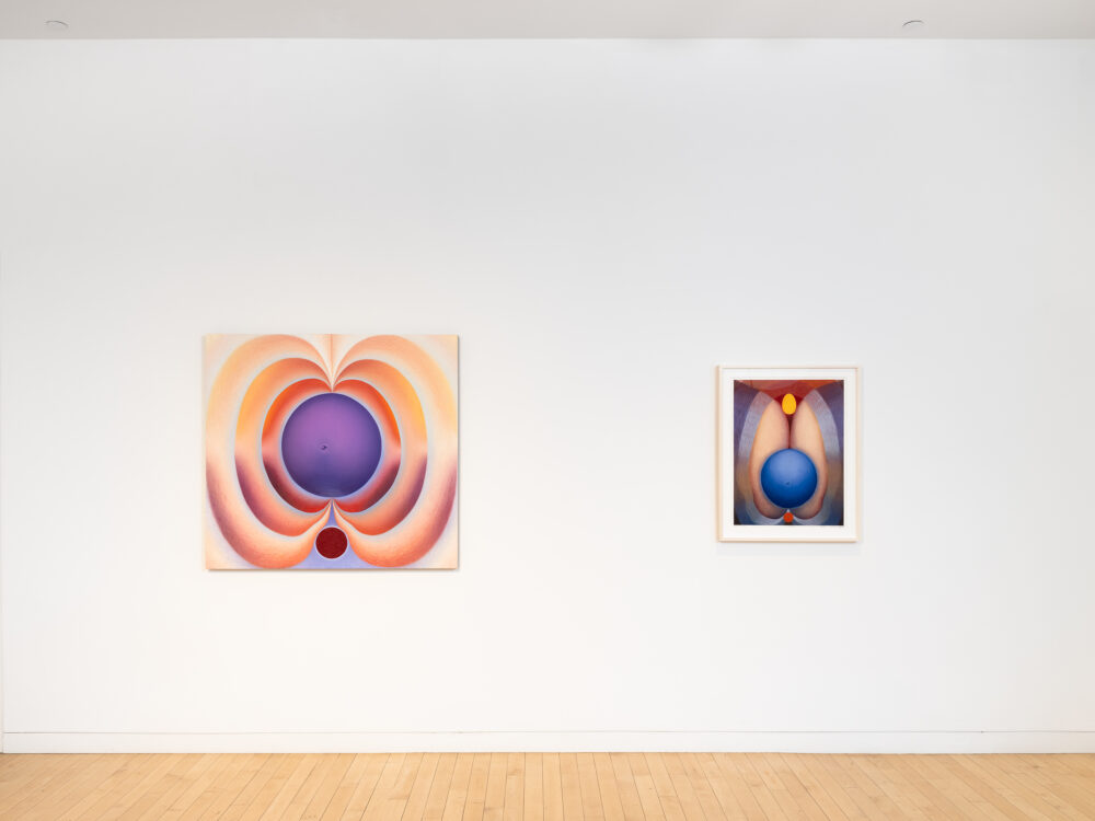 Two large colorful works of art hung on a wall.