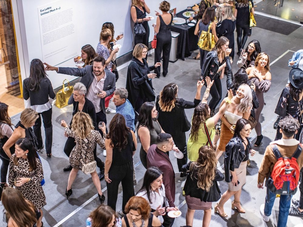 A large group of guests in the Museum's lobby.