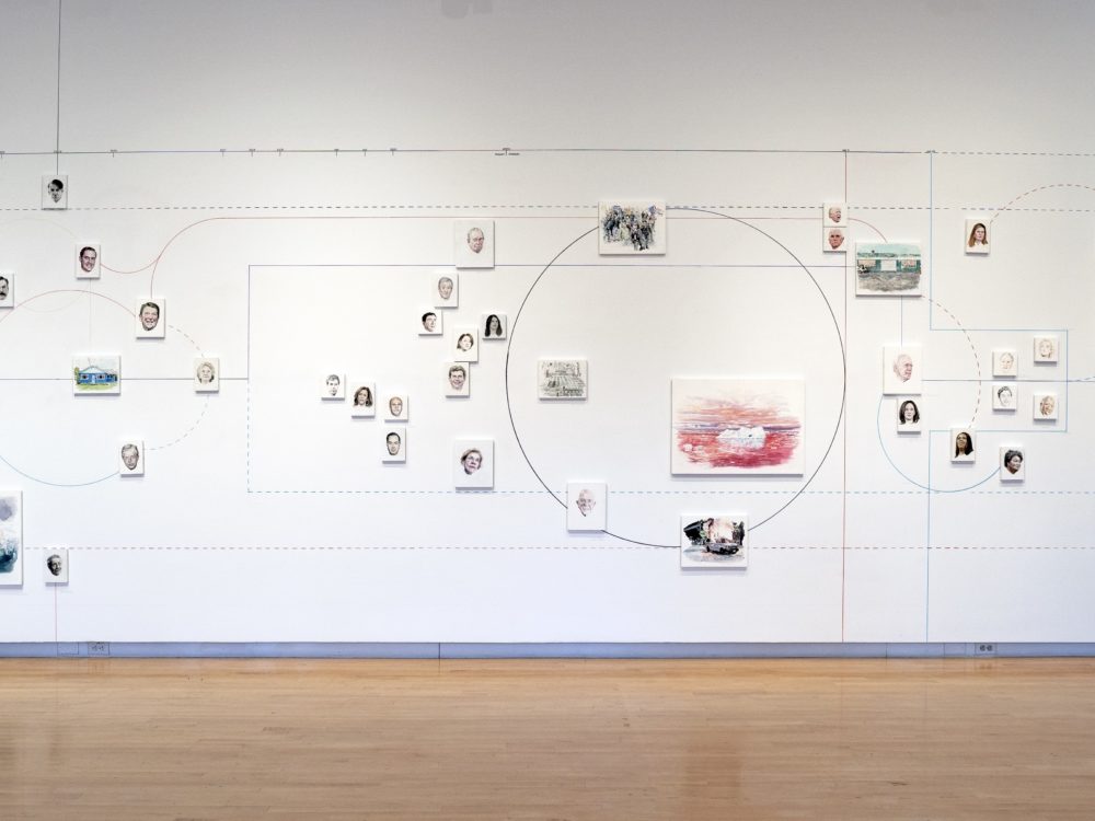 Installation of a timeline on a wall featuring portraits of politicians and images of important current events.