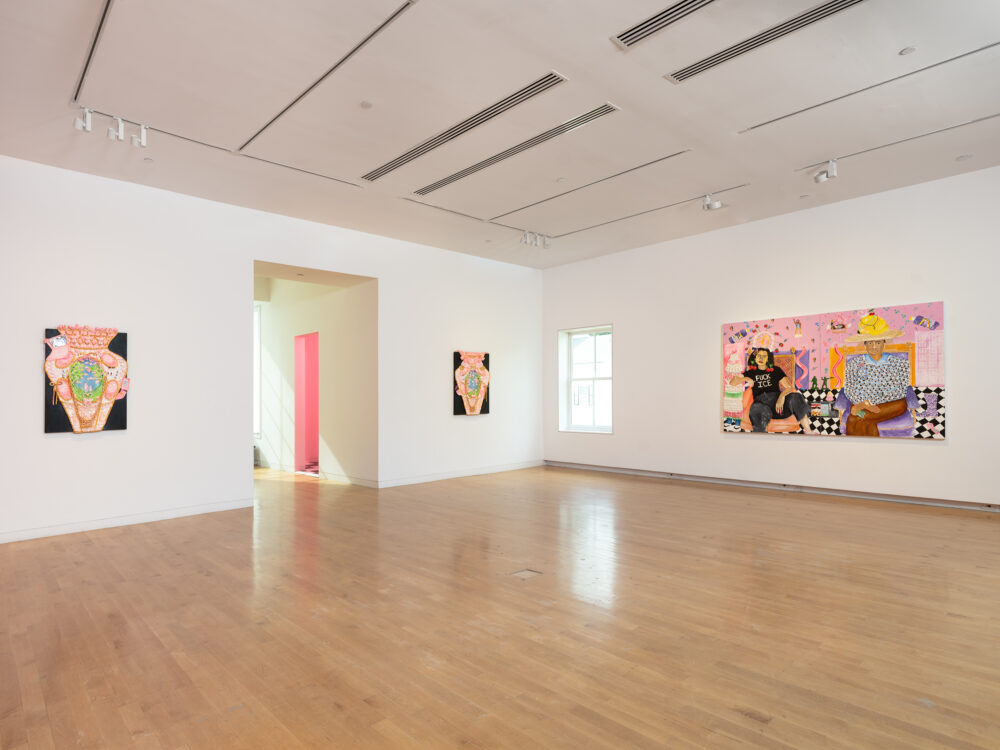 Three paintings hung on white walls.