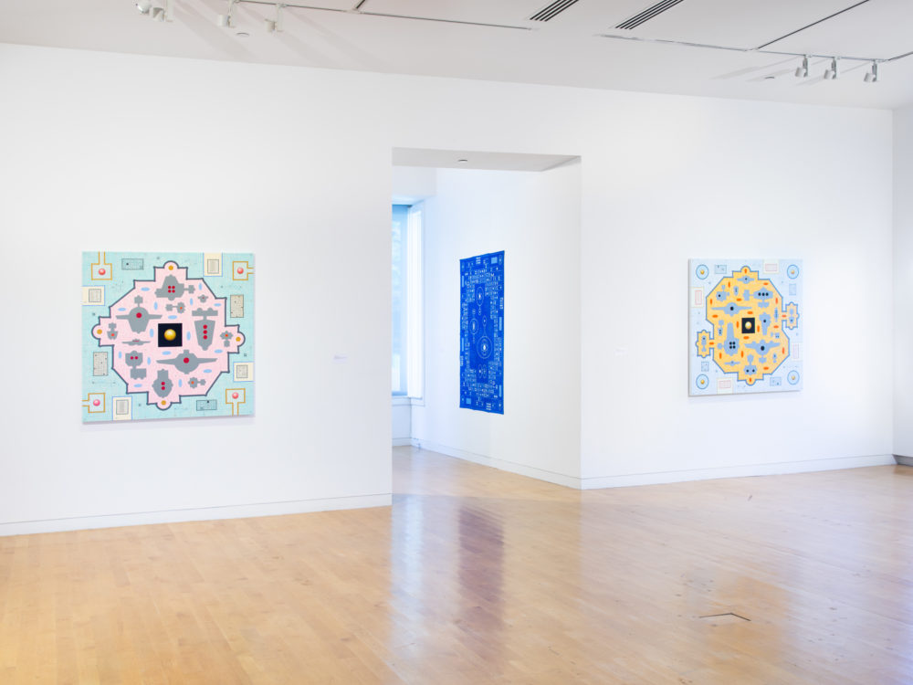 Gallery space with two paintings on a wall in the foreground and a blue painting at an angle through a doorway.