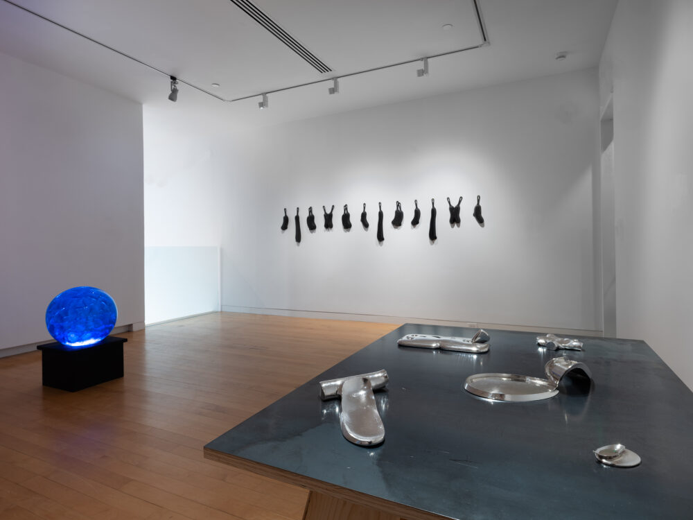 A museum gallery with various artworks relating to the periodic table of elements on display