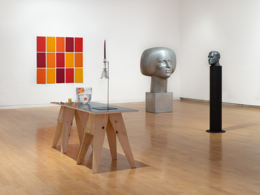 A museum gallery with various artworks relating to the periodic table of elements on display