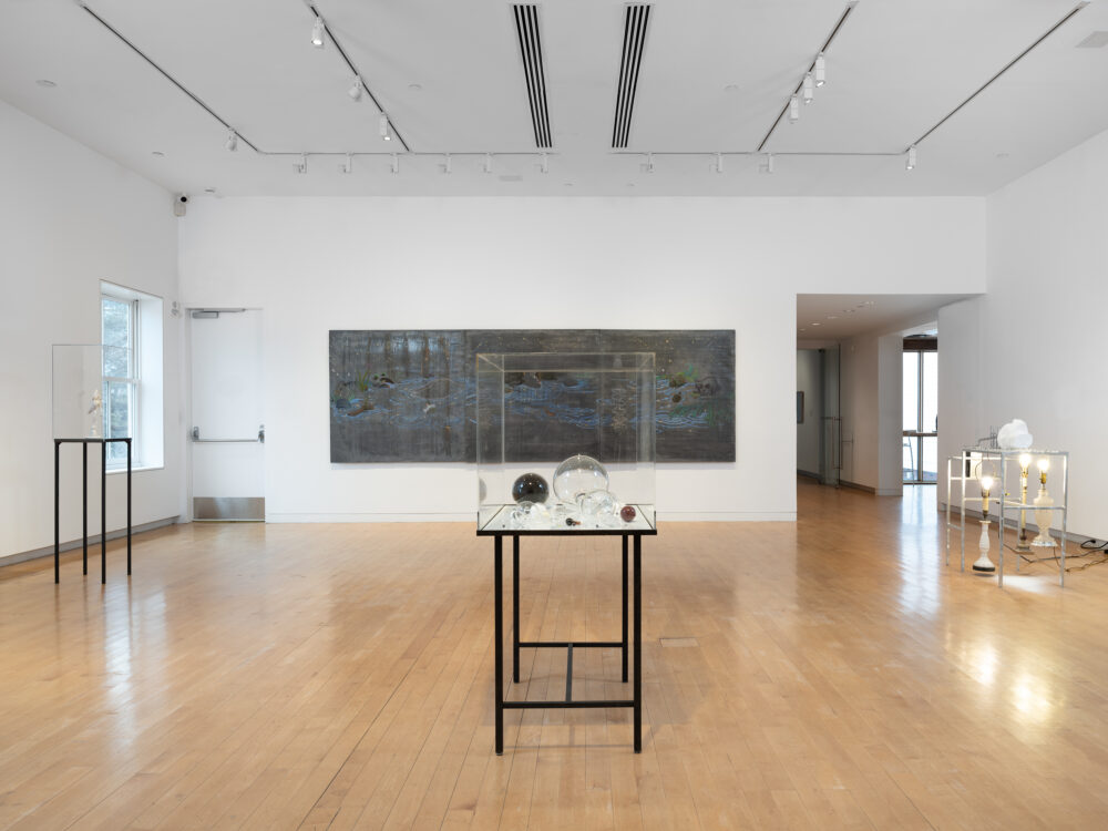 A museum gallery with various artworks relating to the periodic table of elements on display