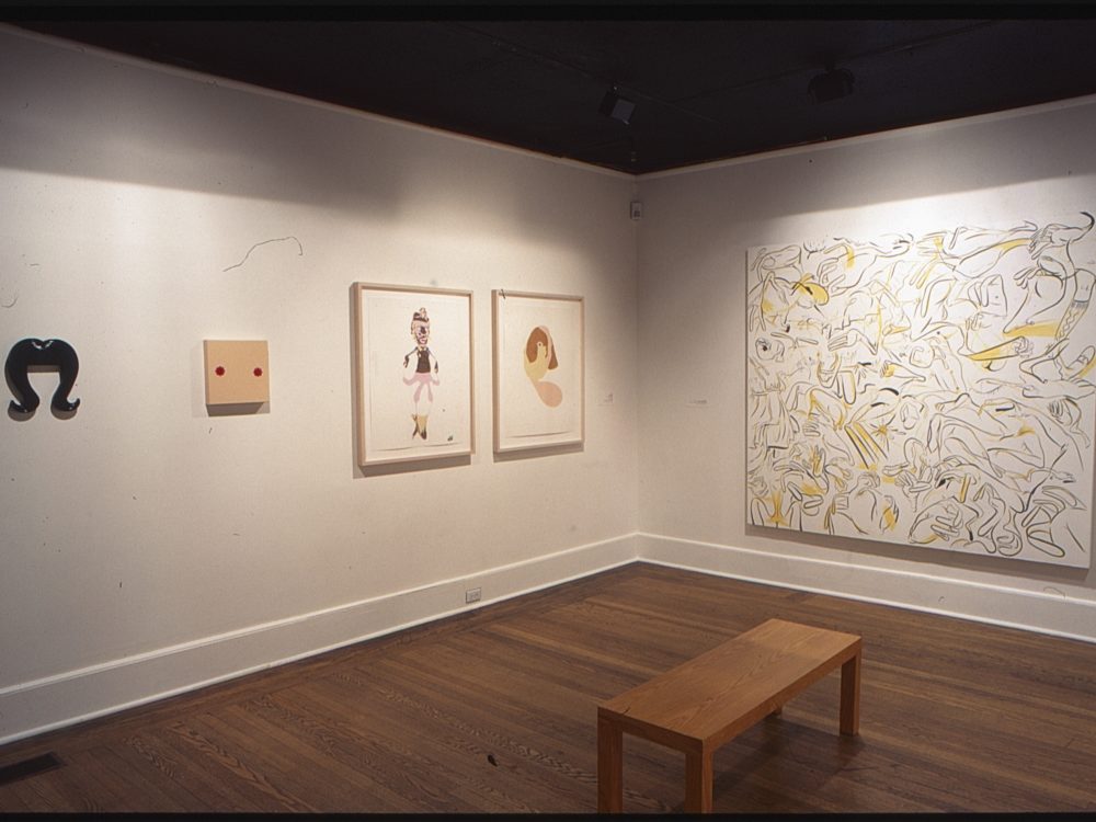 This is a photograph from the Pop Surrealism exhibition which features many vibrant contemporary works of art